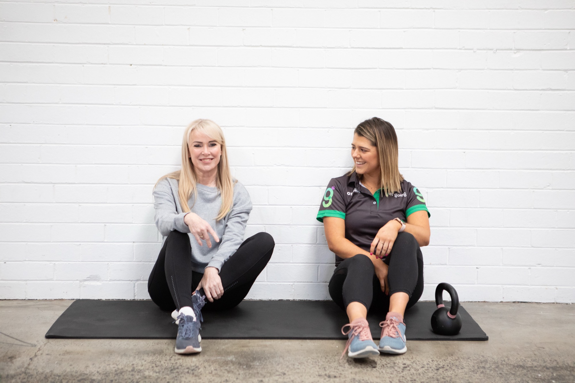 Female personal trainer coaching a client in her Melbourne home